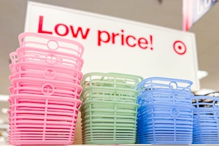 Three colors (pink, green & blue) Brighroom jelly baskets in Target store on shelf with "Low price!" sign in background