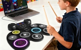 a kid playing on an electric drum set
