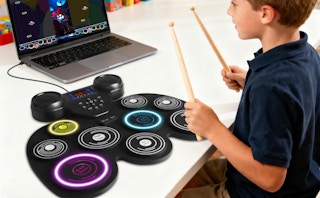 a kid playing on an electric drum set
