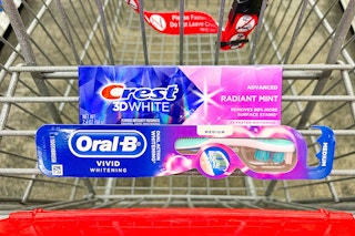crest toothpaste and oral b toothbrush in a shopping cart
