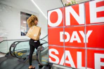 macys one day sale sign with a model