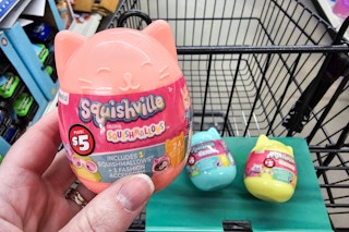 squishville by squishmallows toys in a cart with a person holding one