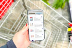 hand holding a smartphone displaying 1-clip coupons in the kcl app