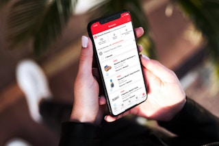 Hand holding a phone with the Vons app showing