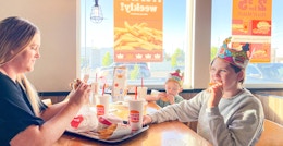 a person and kids eating at burger king
