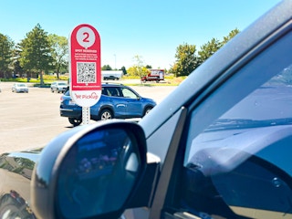 a kroger curbside pick up sign and a close up of a car