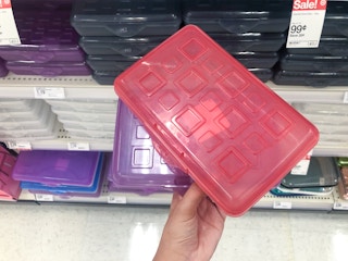 hand holding pencil box in front of school supply display at Target