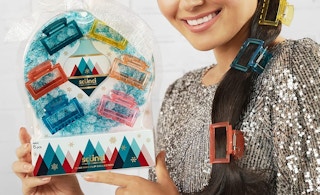 person holding a scunci claw clip holiday gift set