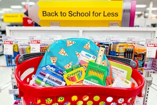 a basket of school supplies at target with a sign that says "back to school for less"