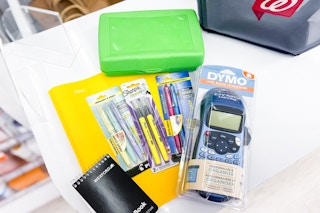 office and school supplies items on a counter next to a walgreens shopping basket
