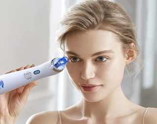 a woman using a blackhead remover