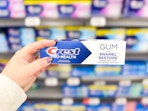 hand holding crest prohealth toothpaste in walmart aisle