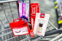 crest and colgate toothpaste, sally hansen nail polish, and kiss eyelashes in a cart
