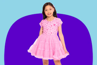Child wearing a pink Barbie-themed tutu dress