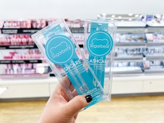 Hand holding two boxes of Sugarbear Lash Serum