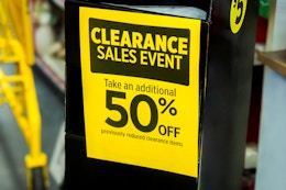 Yellow sign for the Dollar General Clearance Event, showing 50% off previously reduced clearance items.