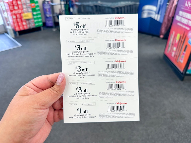 person holding paper coupons