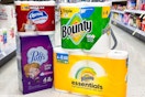 bounty, charmin, and puffs products on the floor in front of a cart