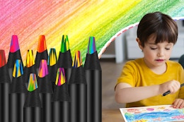 Twelve rainbow pencils on a rainbow penciled background and a little boy holding one about to color.