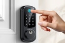 person pressing keypad on door lock