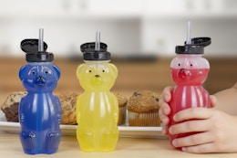 a child with a bear juice cup