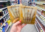 hand holding two boxes of pantene miracle rescue shots