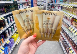hand holding two boxes of pantene miracle rescue shots