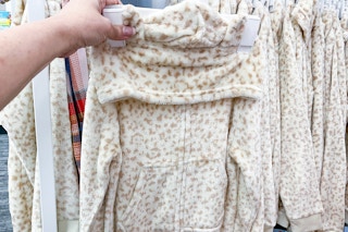 hand holding a cat & jack union suit at target