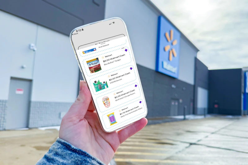 hand holding a smartphone displaying kcl 1-clip coupons