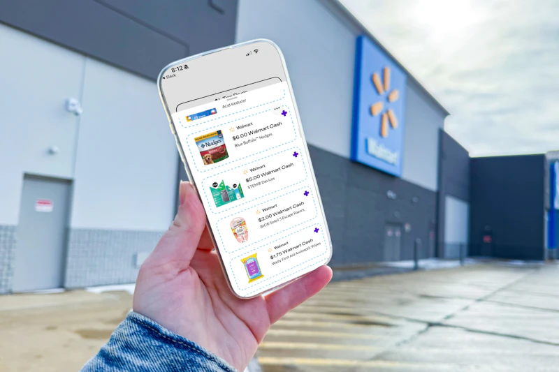 hand holding a smartphone displaying kcl 1-clip coupons