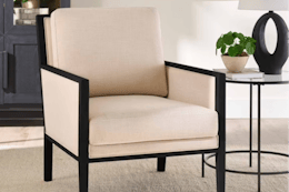 cream colored accent chair with black wood