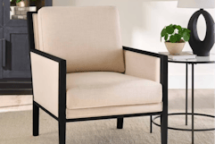 cream colored accent chair with black wood