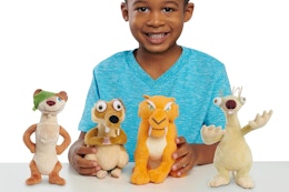 a boy with a set of four just play ice age plushies
