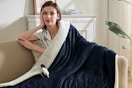 Woman using the Easthome Electric Heated Throw Blanket - Waffle Sherpa 50"x60" in a chair. 