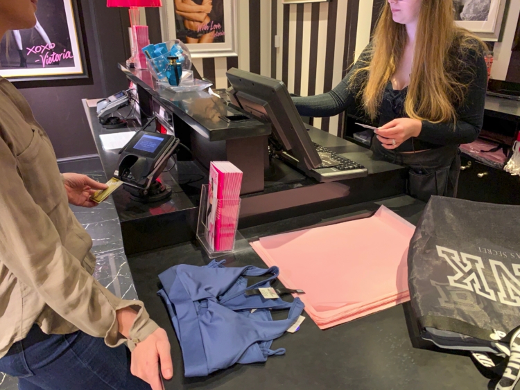 Employee ringing up customers purchase at the register.