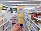 hand holding vaseline hand butter in walgreens