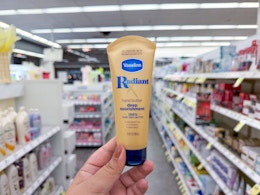 hand holding vaseline hand butter in walgreens