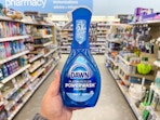 hand holding dawn dish spray in walgreens