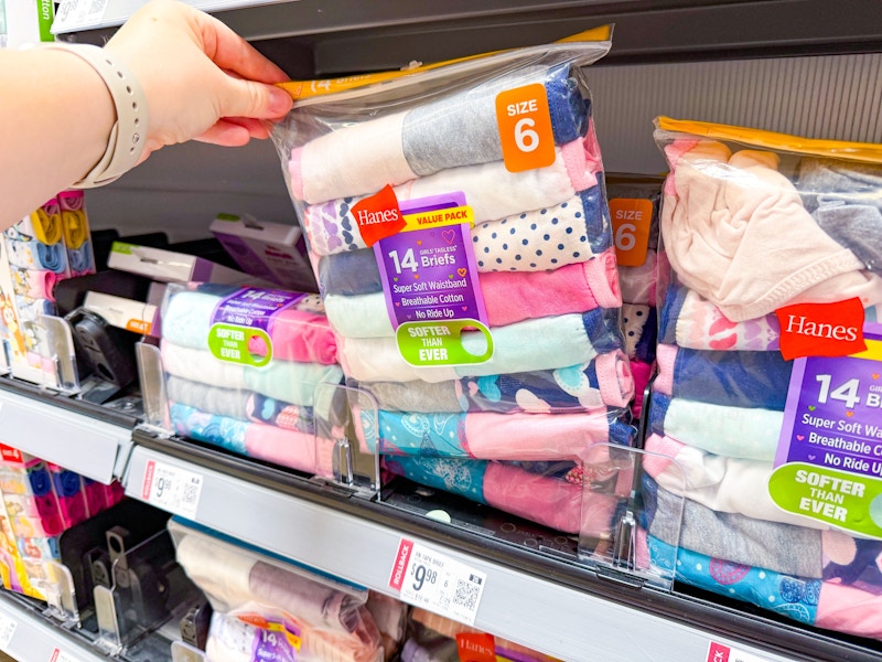hand holding a pack of hanes girls briefs underwear on walmart shelf