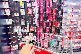 person pushing a cart towards a beauty aisle