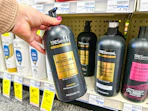 hand holding tresemme shampoo bottle