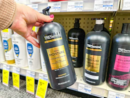 hand holding tresemme shampoo bottle