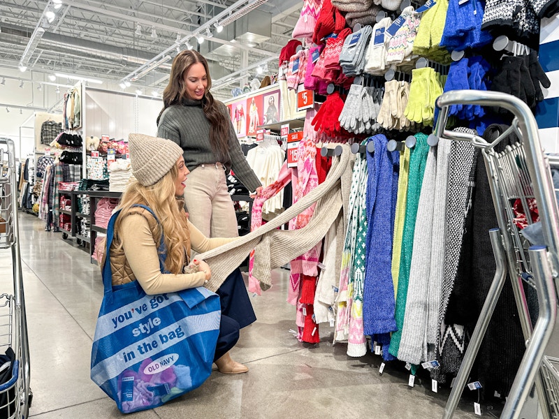 two woman looking at scarfs in Old Navy store 