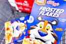 2 boxes of kelloggs frosted flakes cereal in a cart