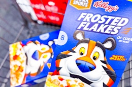 2 boxes of kelloggs frosted flakes cereal in a cart