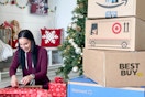 a woman wrapping gifts by a huge stack of online order boxes
