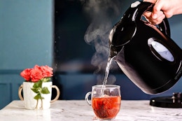 Black Ovente Electric Kettle (lifestyle image of water being poured to make a cup of tea)