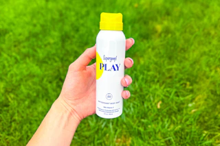 a person holding supergoop play sunscreen 