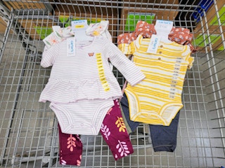 carters baby outfit sets in a cart