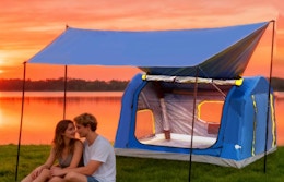 two people sitting under an inflatable tent 